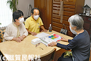 家賃補助打ち切りについて入居者と話す日本共産党市議写真